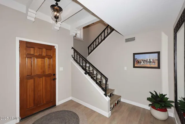 a view of entryway and hall with a potted plant