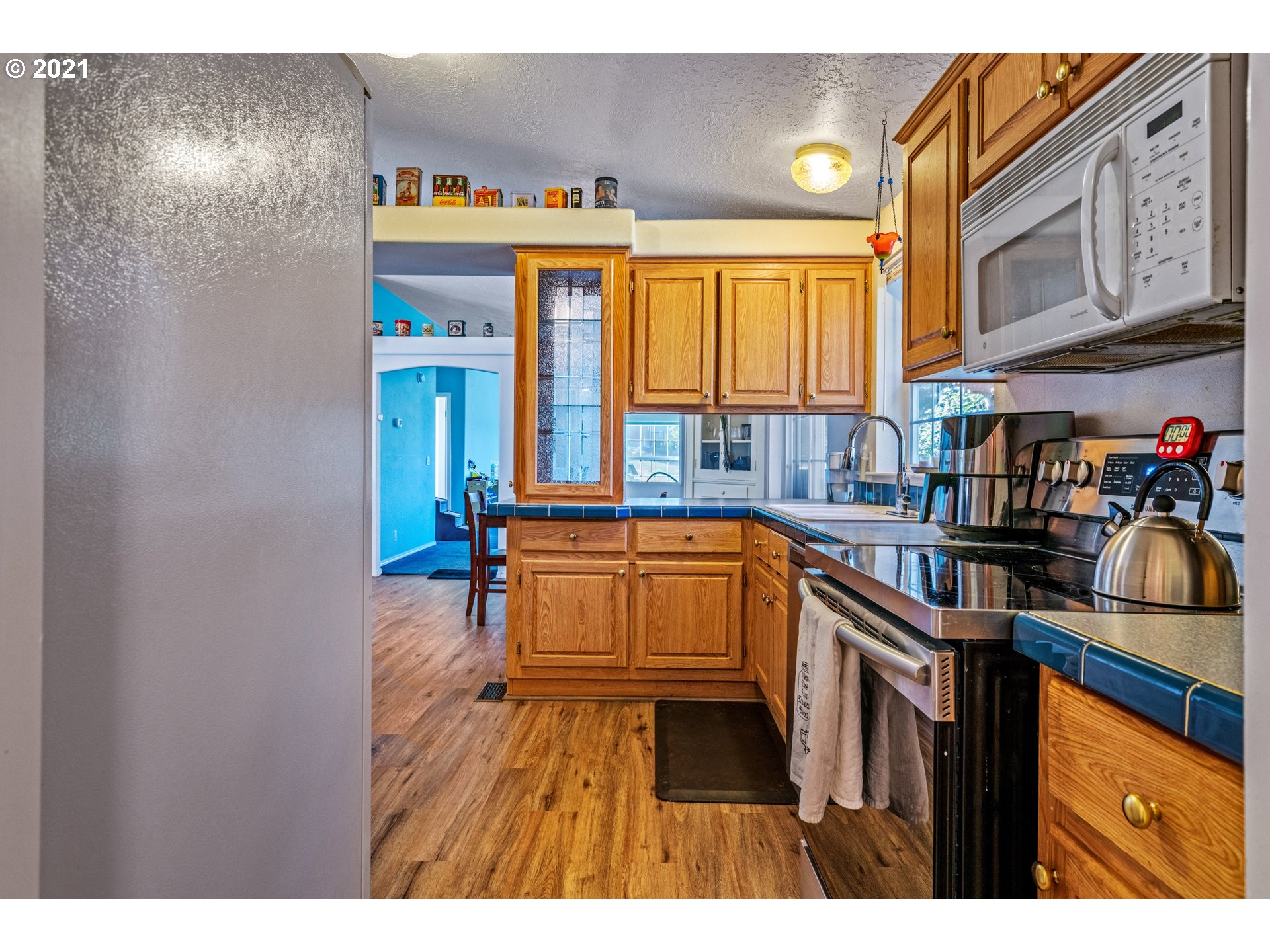 15010 Ferns Corner Road Dallas, OR 97338 - Photo 13 of 32 a kitchen that has a lot of cabinets in it and a window