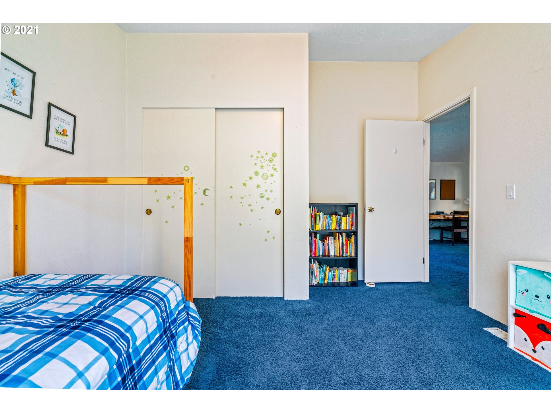 15010 Ferns Corner Road Dallas, OR 97338 - Photo 21 of 32 a bedroom with a bed and a refrigerator