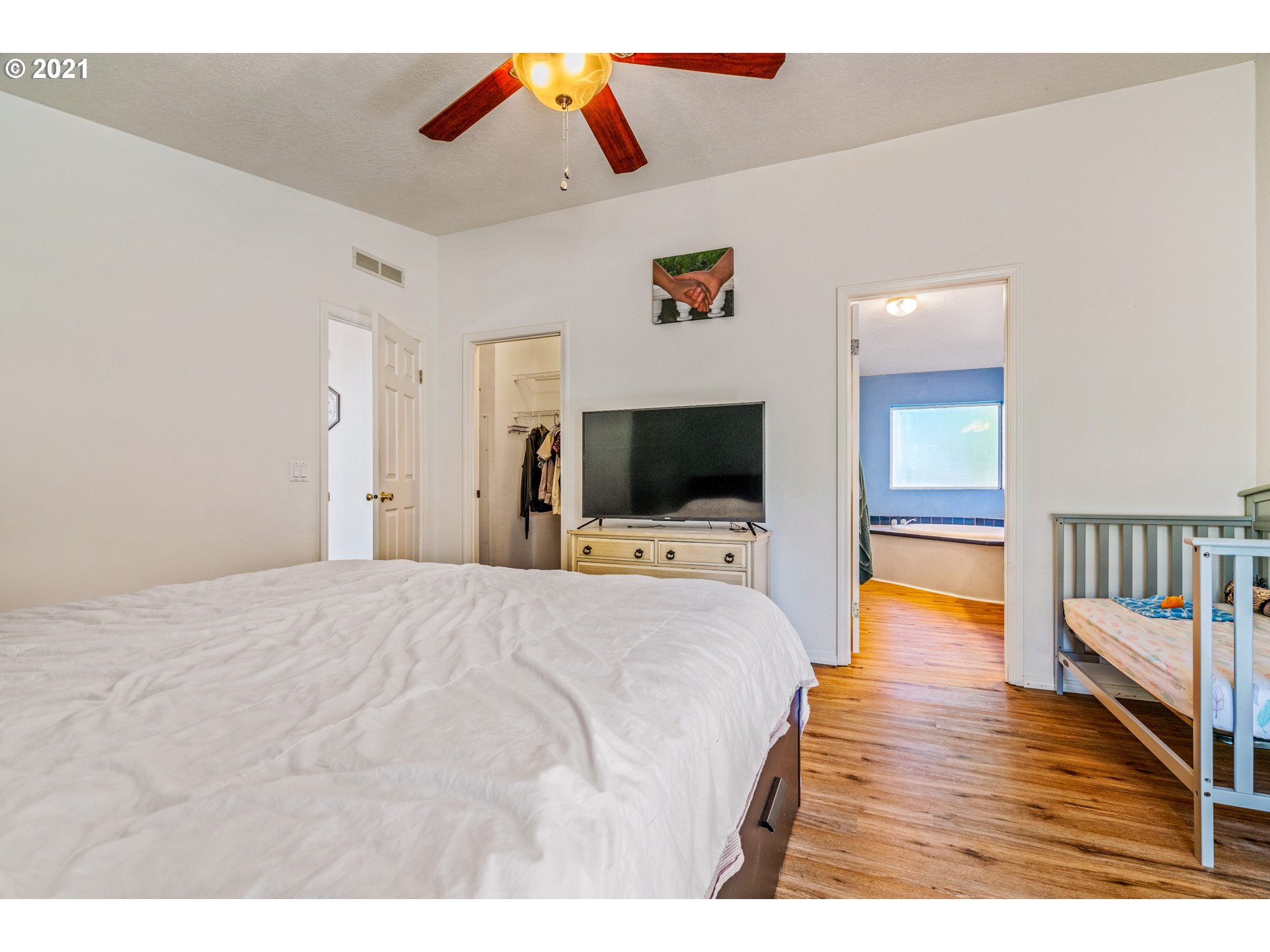 15010 Ferns Corner Road Dallas, OR 97338 - Photo 24 of 32 a bedroom with a bed and a flat screen tv