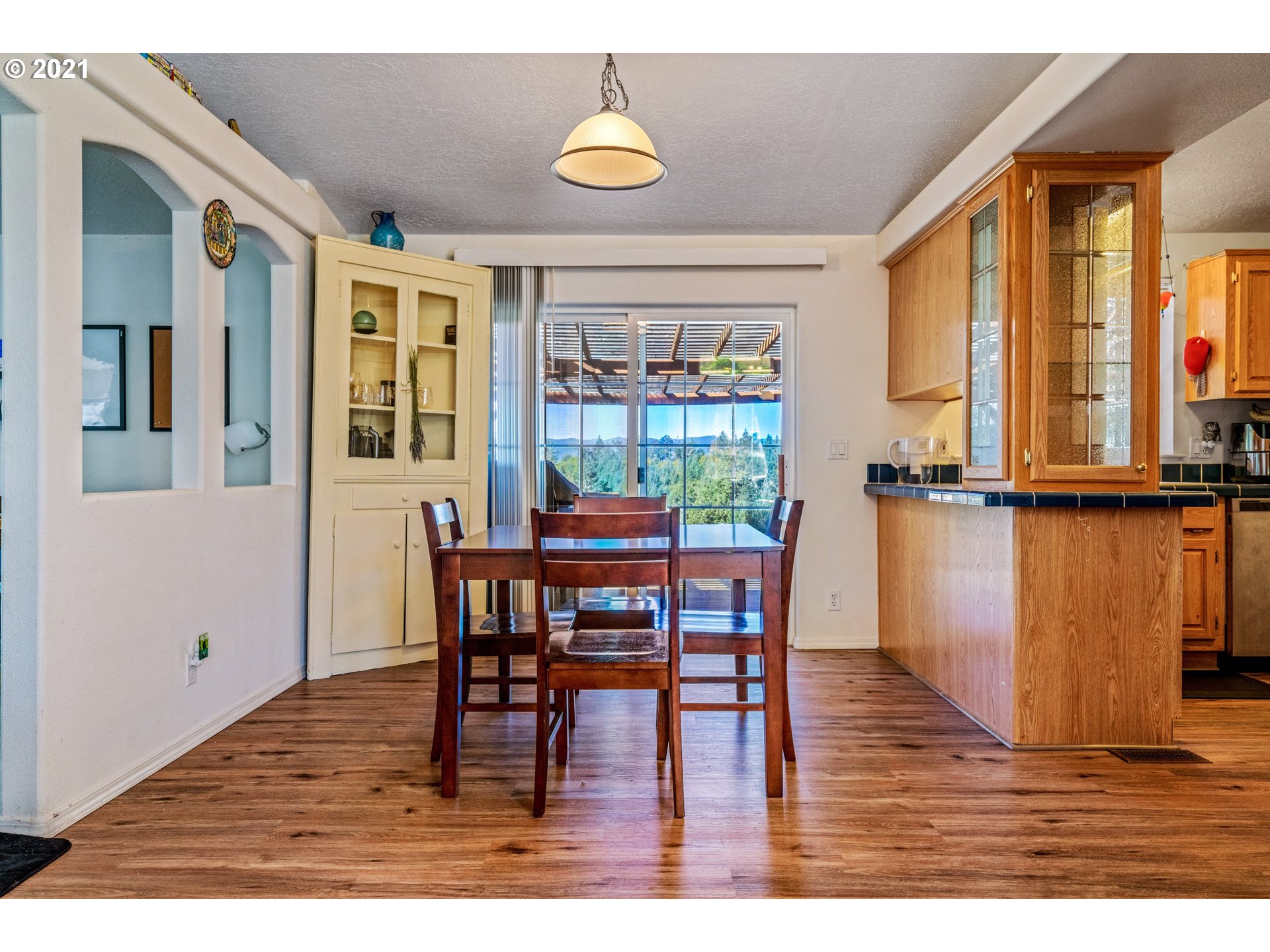 15010 Ferns Corner Road Dallas, OR 97338 - Photo 10 of 32 a view of a dining room with furniture and wooden floor