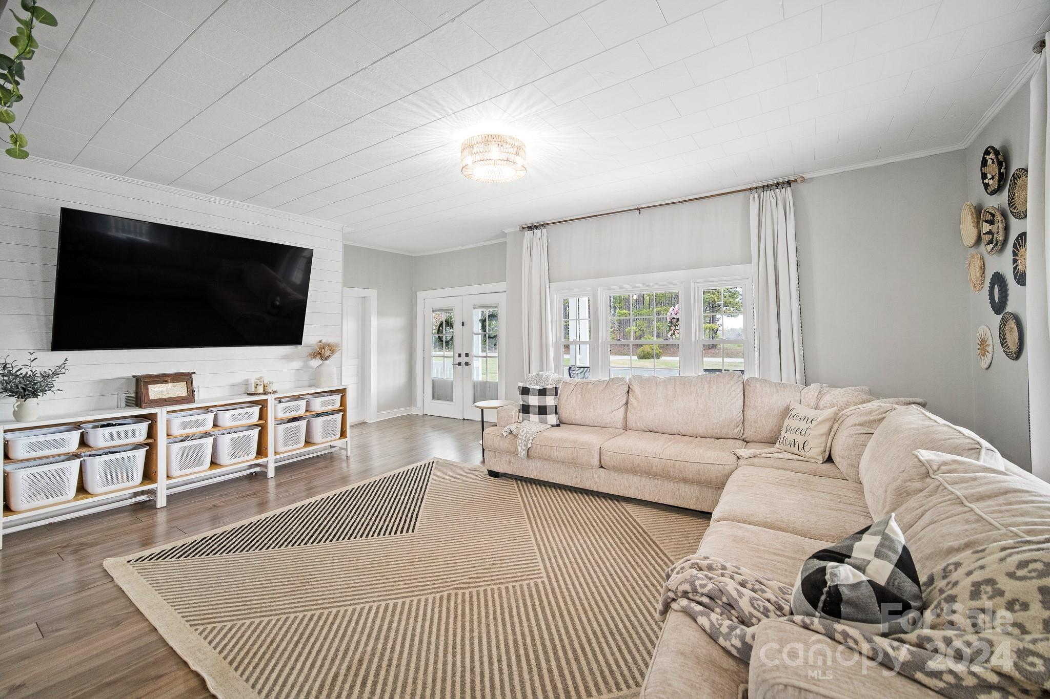 8375 Woodleaf Road Woodleaf, NC 27054 - Photo 11 of 35 a living room with furniture and a flat screen tv