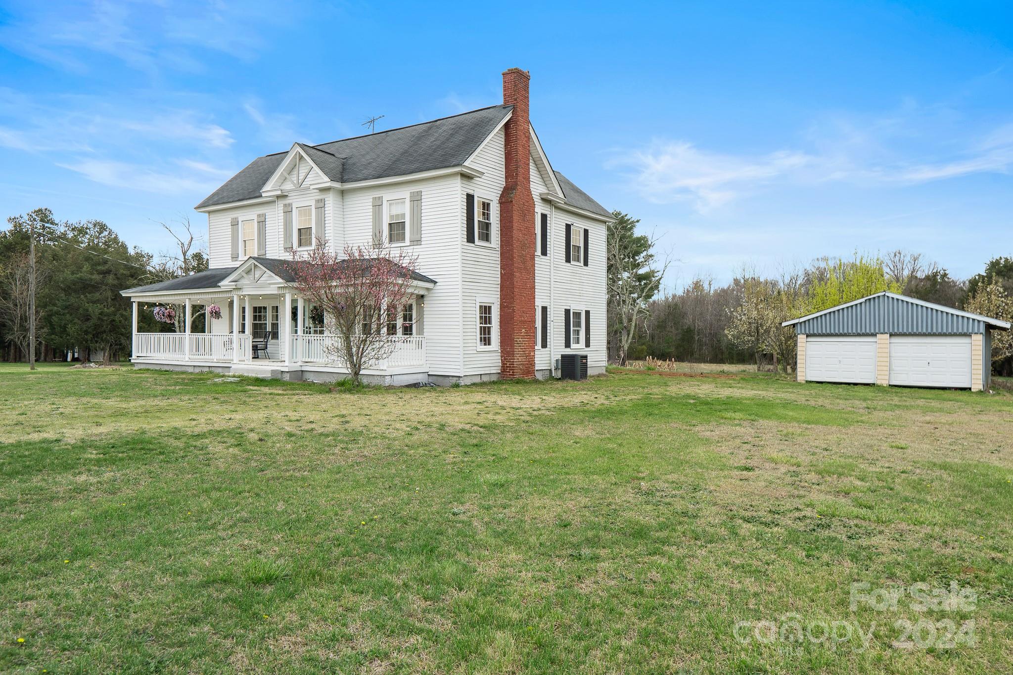 8375 Woodleaf Road Woodleaf, NC 27054 - Photo 3 of 35 a front view of a house with a yard