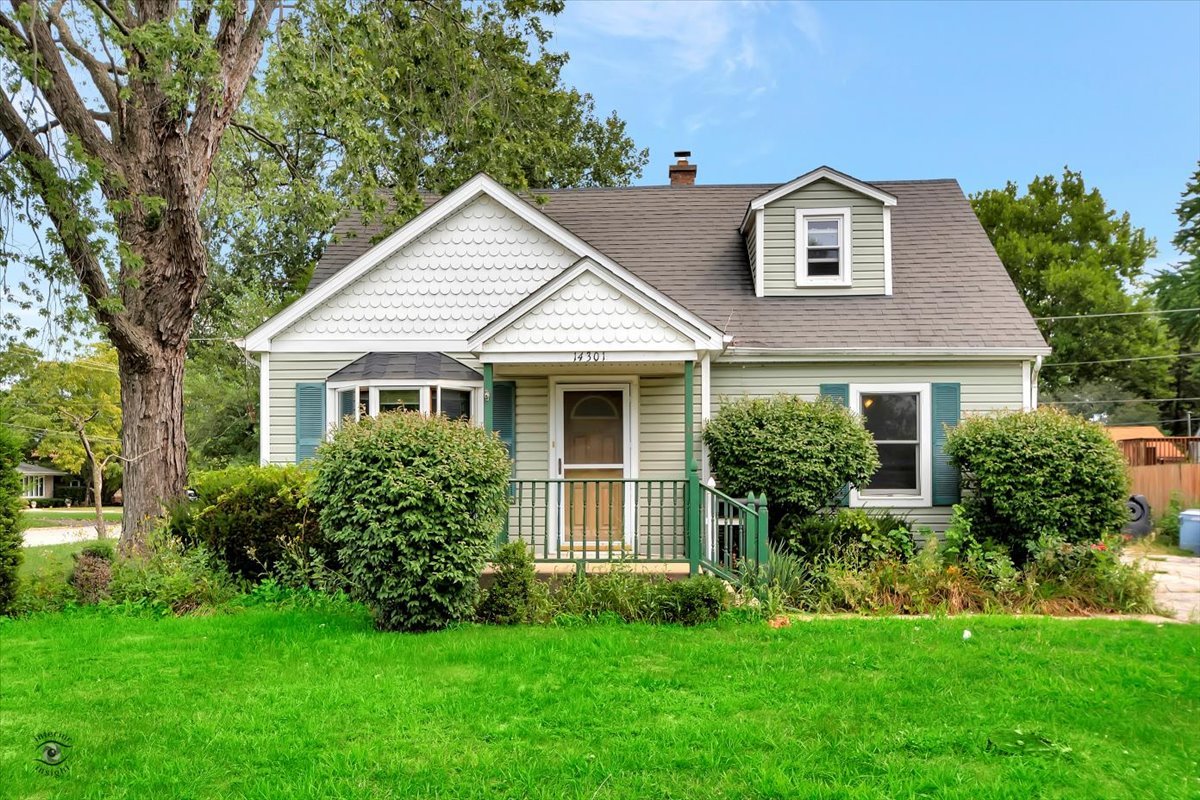 a front view of a house with a garden and yard