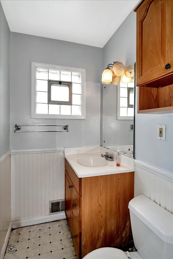 14301 Kilpatrick Avenue Midlothian, IL 60445 - Photo 16 of 22 a bathroom with a sink a toilet and shower
