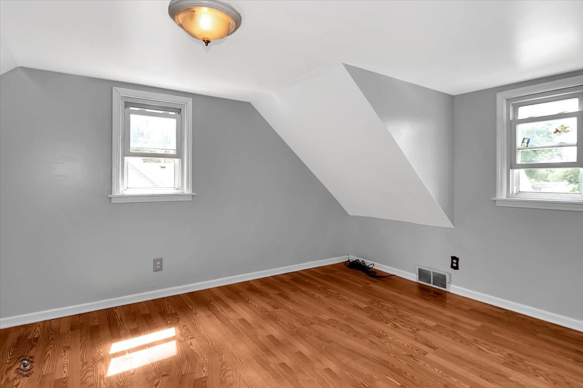 14301 Kilpatrick Avenue Midlothian, IL 60445 - Photo 17 of 22 a view of an empty room with wooden floor and a window