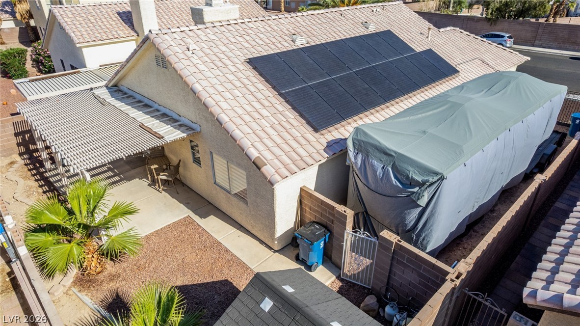 5112 West Camino Del Rancho Las Vegas, NV 89130 - Photo 38 of 44 This captivating aerial view captures a house with solar panels and a charming patio.
