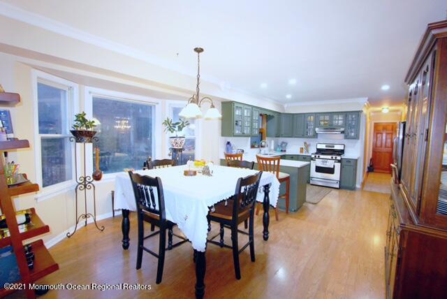 766 Anderson Road Jackson, NJ 08527 - Photo 2 of 21 a view of a dining room and livingroom with furniture wooden floor a rug a painting and a chandelier
