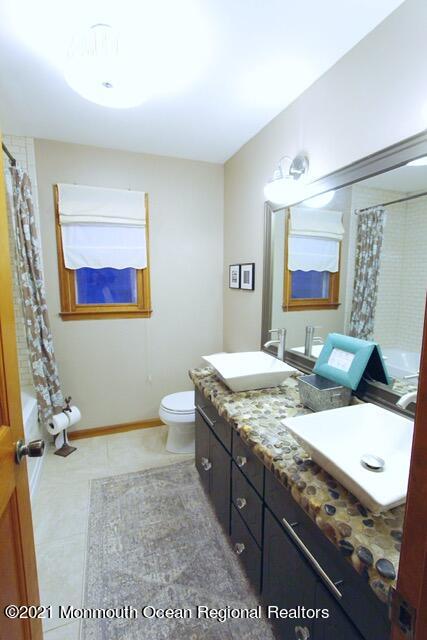 766 Anderson Road Jackson, NJ 08527 - Photo 15 of 21 a bathroom with a granite countertop sink a mirror and a toilet