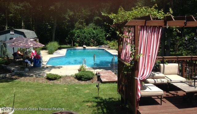 766 Anderson Road Jackson, NJ 08527 - Photo 19 of 21 a backyard of a house with lots of green space and fountain