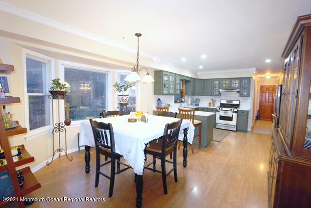 766 Anderson Road Jackson, NJ 08527 - Photo 5 of 21 a view of a dining room and livingroom with furniture wooden floor a chandelier