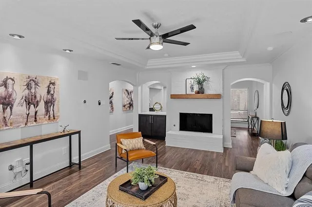 a living room with furniture a fireplace and window