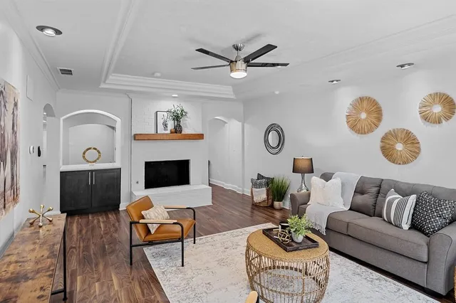 a living room with furniture a rug and a fireplace
