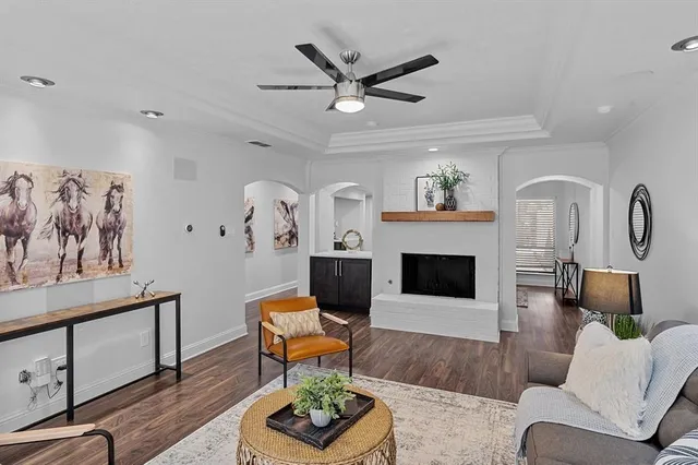 a living room with furniture a fireplace and window