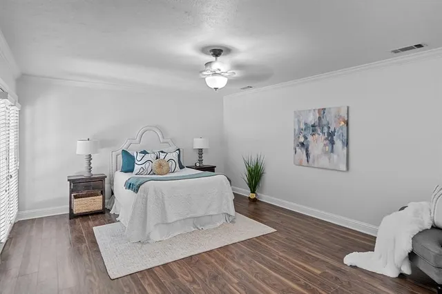 a bedroom with bed and a chandelier