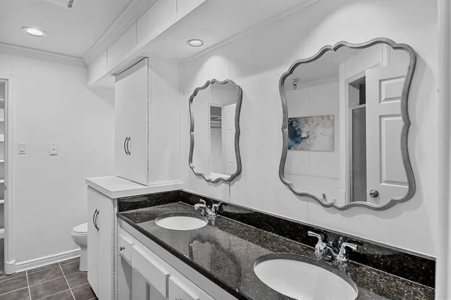 a bathroom with a double vanity sink and mirror