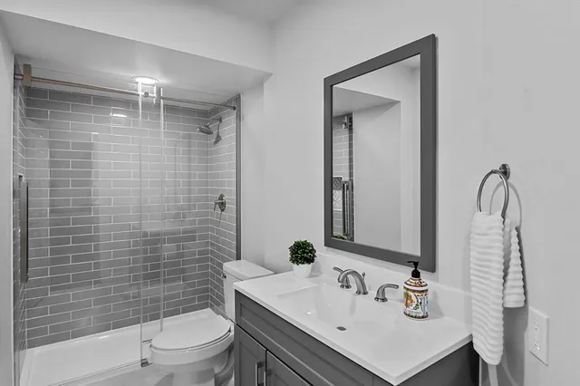 a bathroom with a sink toilet and shower