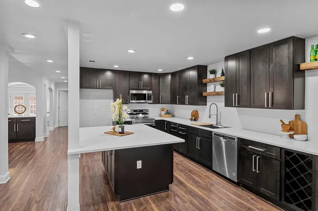 a kitchen with stainless steel appliances a sink stove and refrigerator