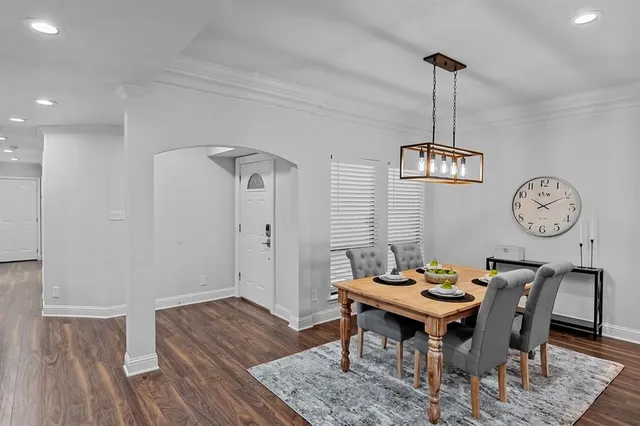 a view of a dining room with furniture wooden floor and a chandelier