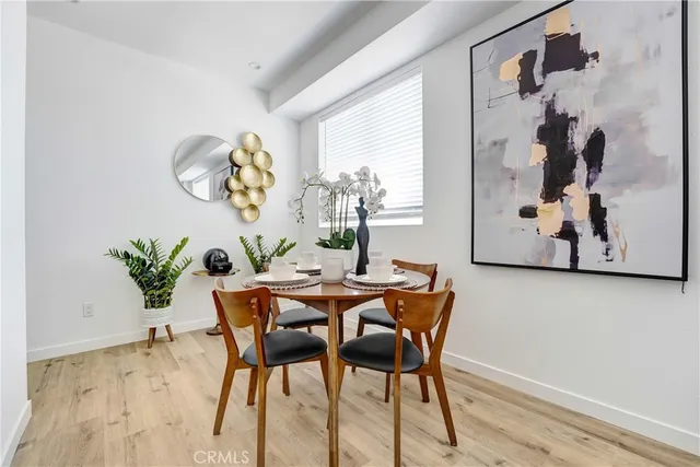 a dining room with furniture and wooden floor