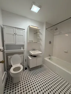 a bathroom with a toilet a sink and a bathtub