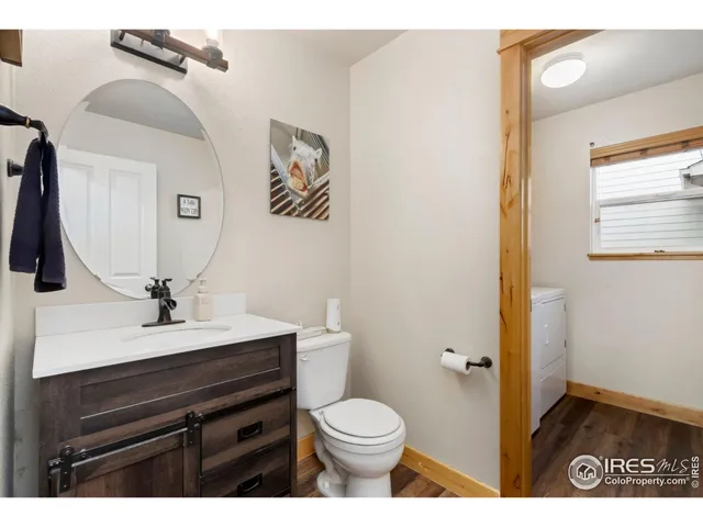 a bathroom with a sink a toilet and mirror