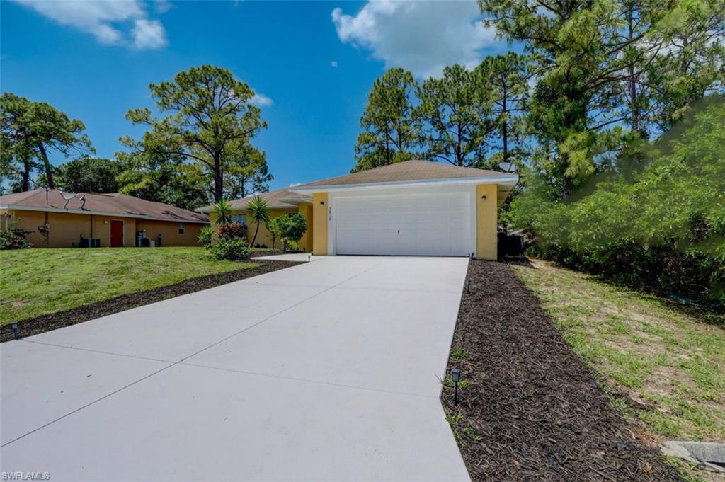 2812 4th Street Southwest Lehigh Acres, FL 33976 - Photo 1 of 34 front view of a house with a yard