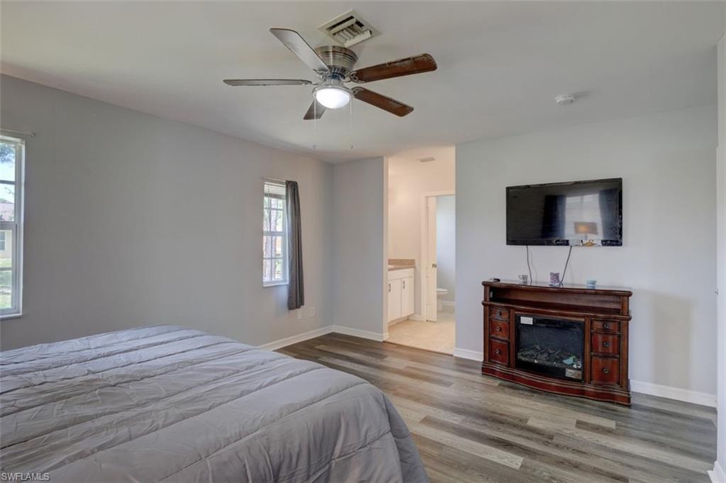 2812 4th Street Southwest Lehigh Acres, FL 33976 - Photo 20 of 34 a bedroom with a bed and a flat screen tv