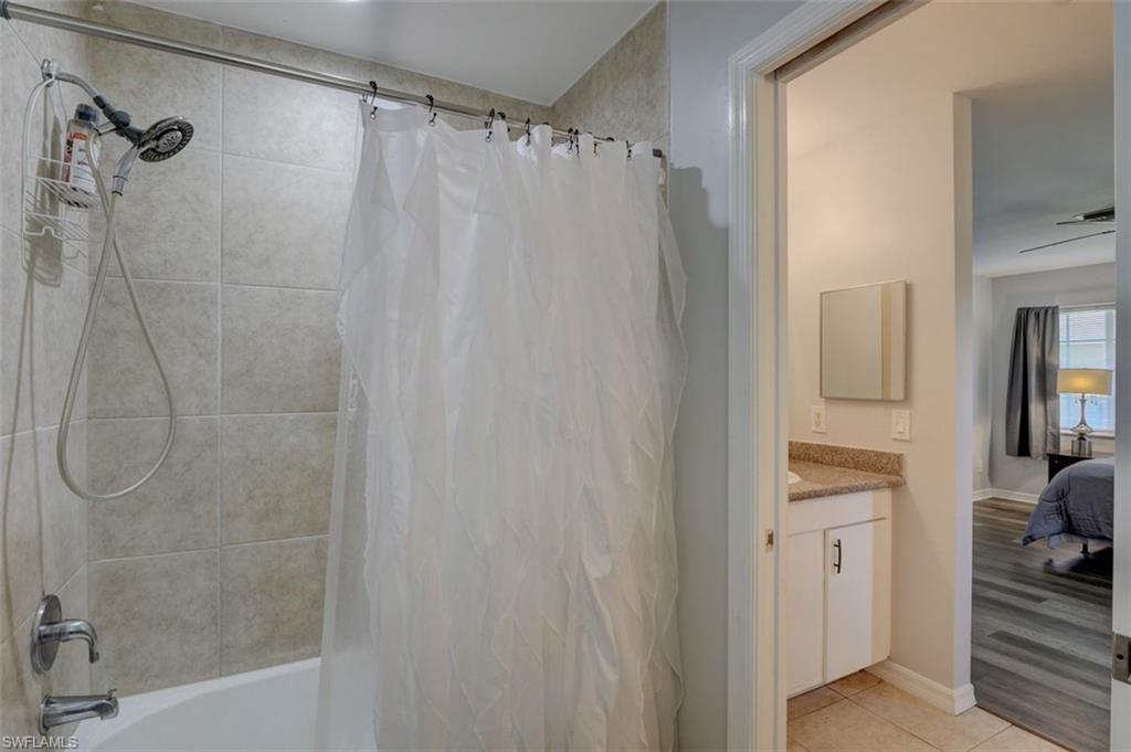 2812 4th Street Southwest Lehigh Acres, FL 33976 - Photo 23 of 34 a bathroom with a shower curtain and a sink