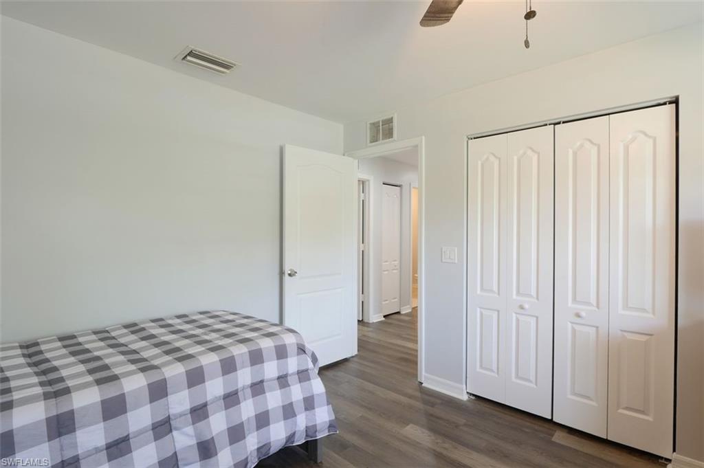 2812 4th Street Southwest Lehigh Acres, FL 33976 - Photo 27 of 34 a bedroom with a bed and a walk in closet