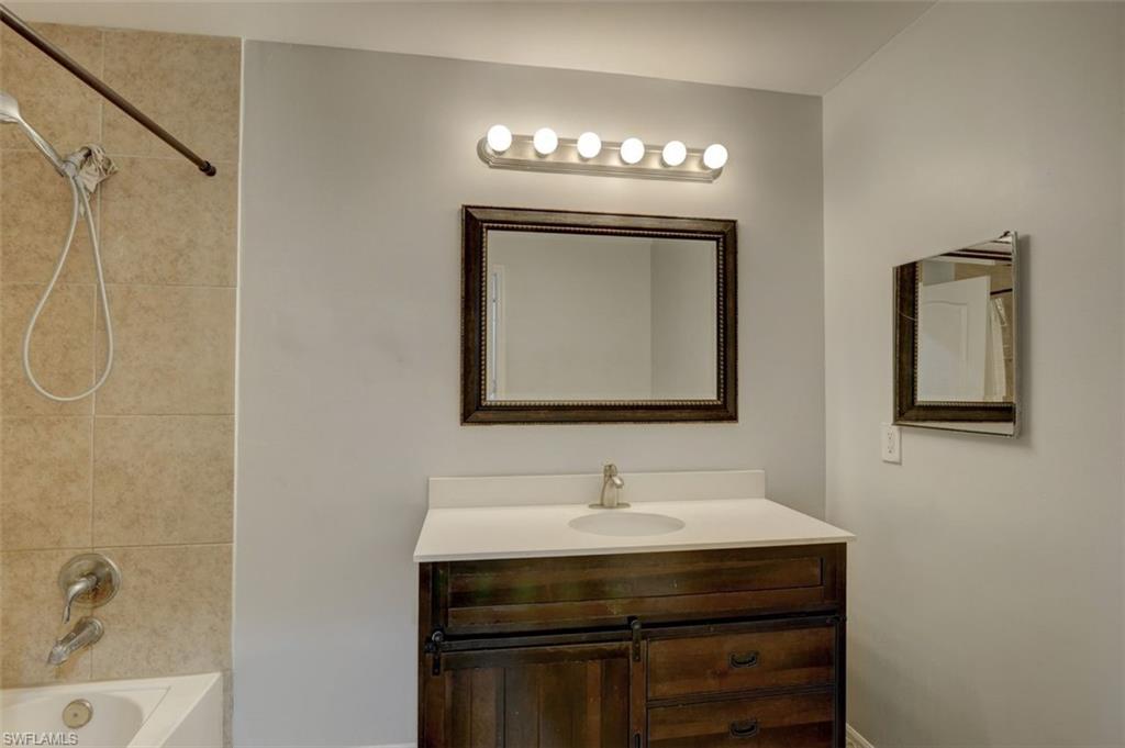 2812 4th Street Southwest Lehigh Acres, FL 33976 - Photo 28 of 34 a bathroom with a sink and a mirror