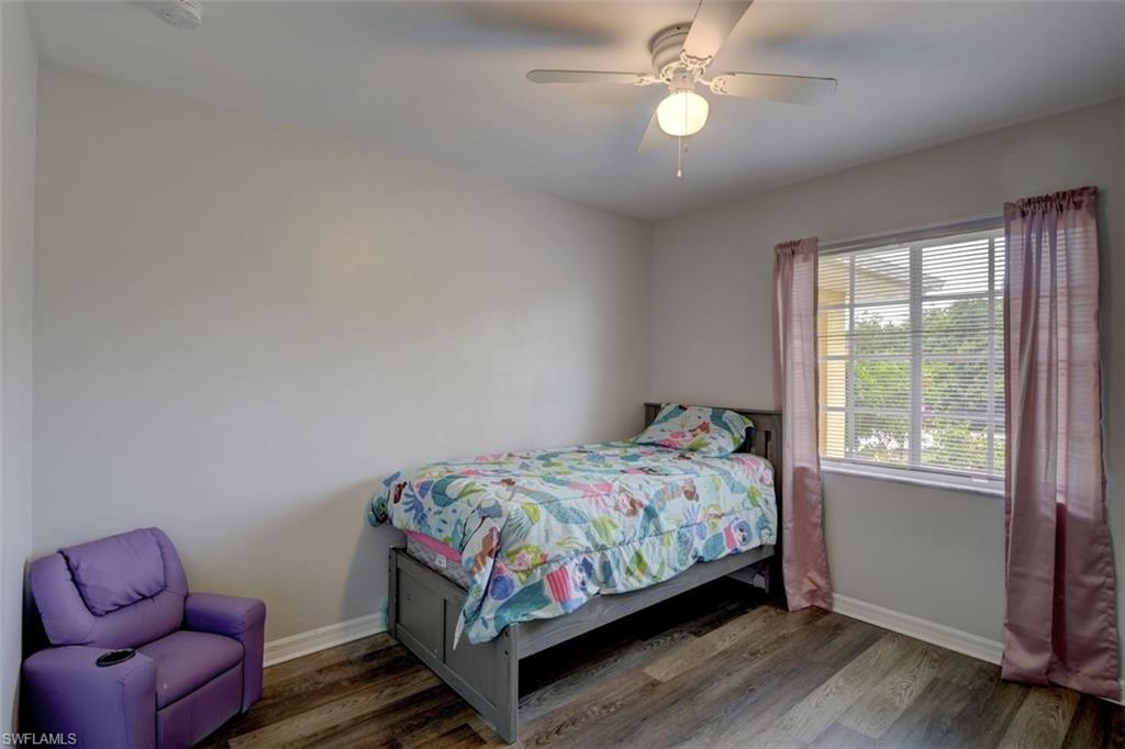 2812 4th Street Southwest Lehigh Acres, FL 33976 - Photo 29 of 34 a bedroom with a bed couch and window