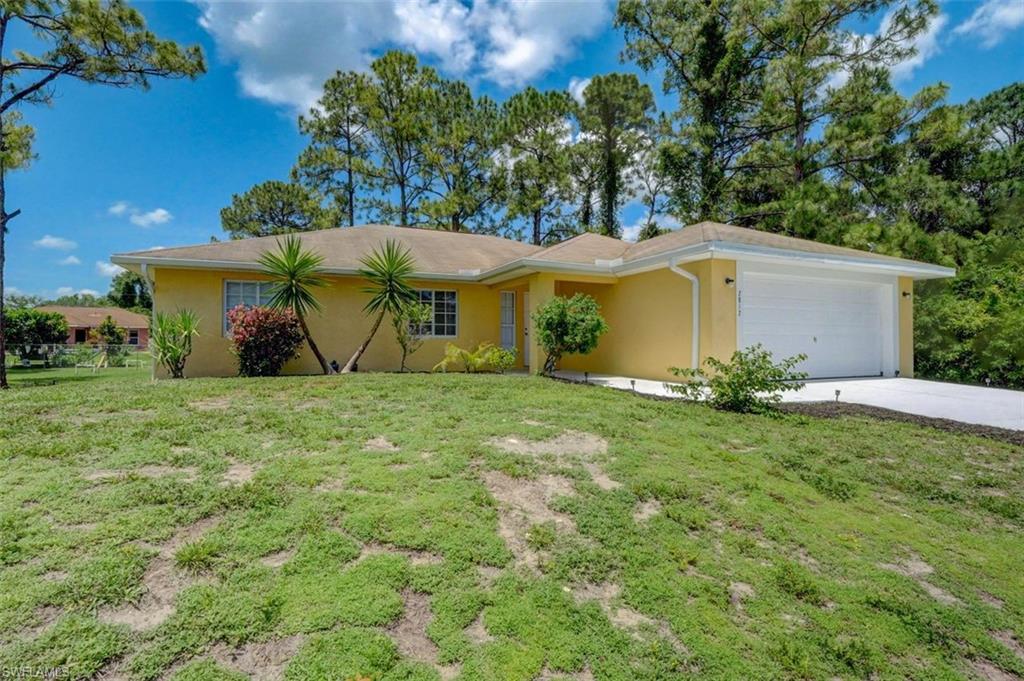 2812 4th Street Southwest Lehigh Acres, FL 33976 - Photo 3 of 34 a view of a backyard with a garden