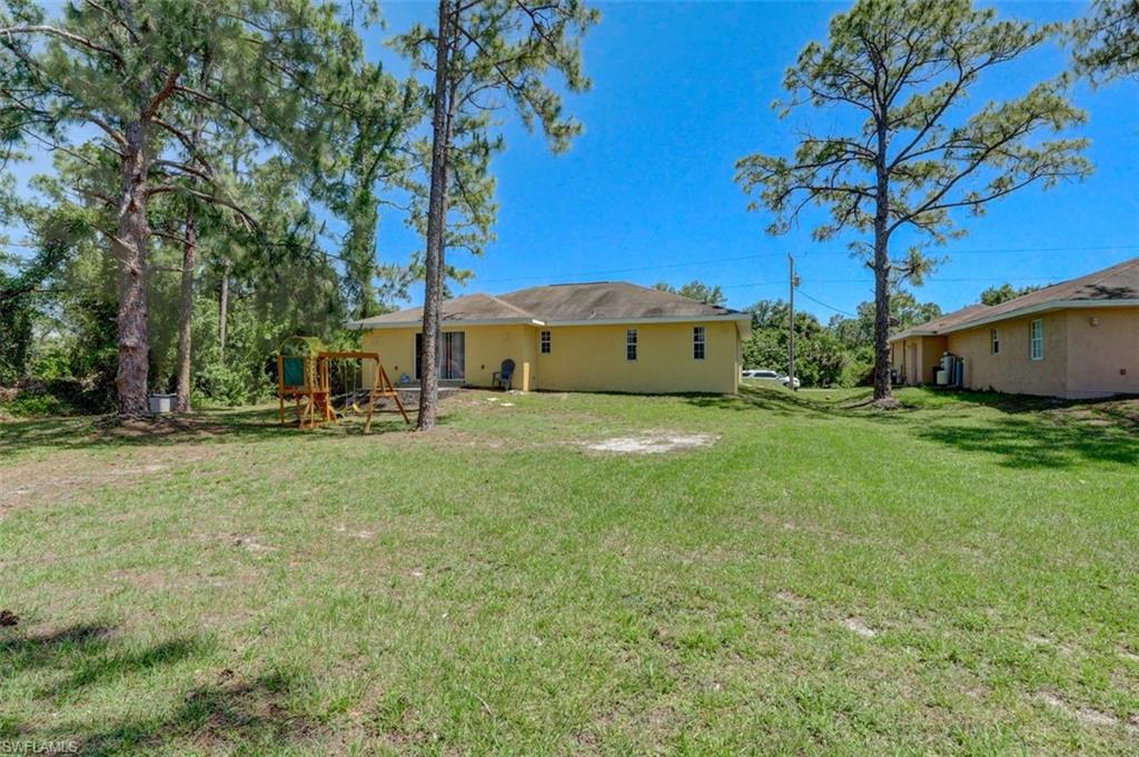 2812 4th Street Southwest Lehigh Acres, FL 33976 - Photo 33 of 34 a view of a house with a big yard