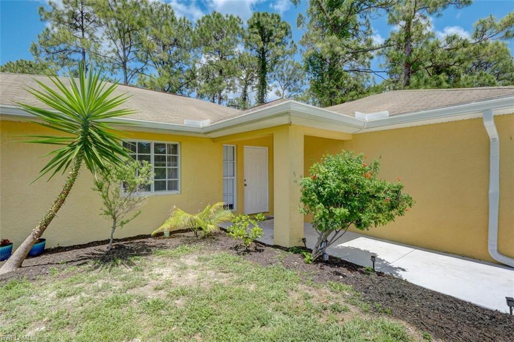 2812 4th Street Southwest Lehigh Acres, FL 33976 - Photo 4 of 34 a view of a house with a tree