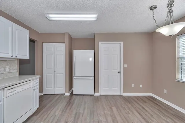 a view of a kitchen with wooden floor and a sink