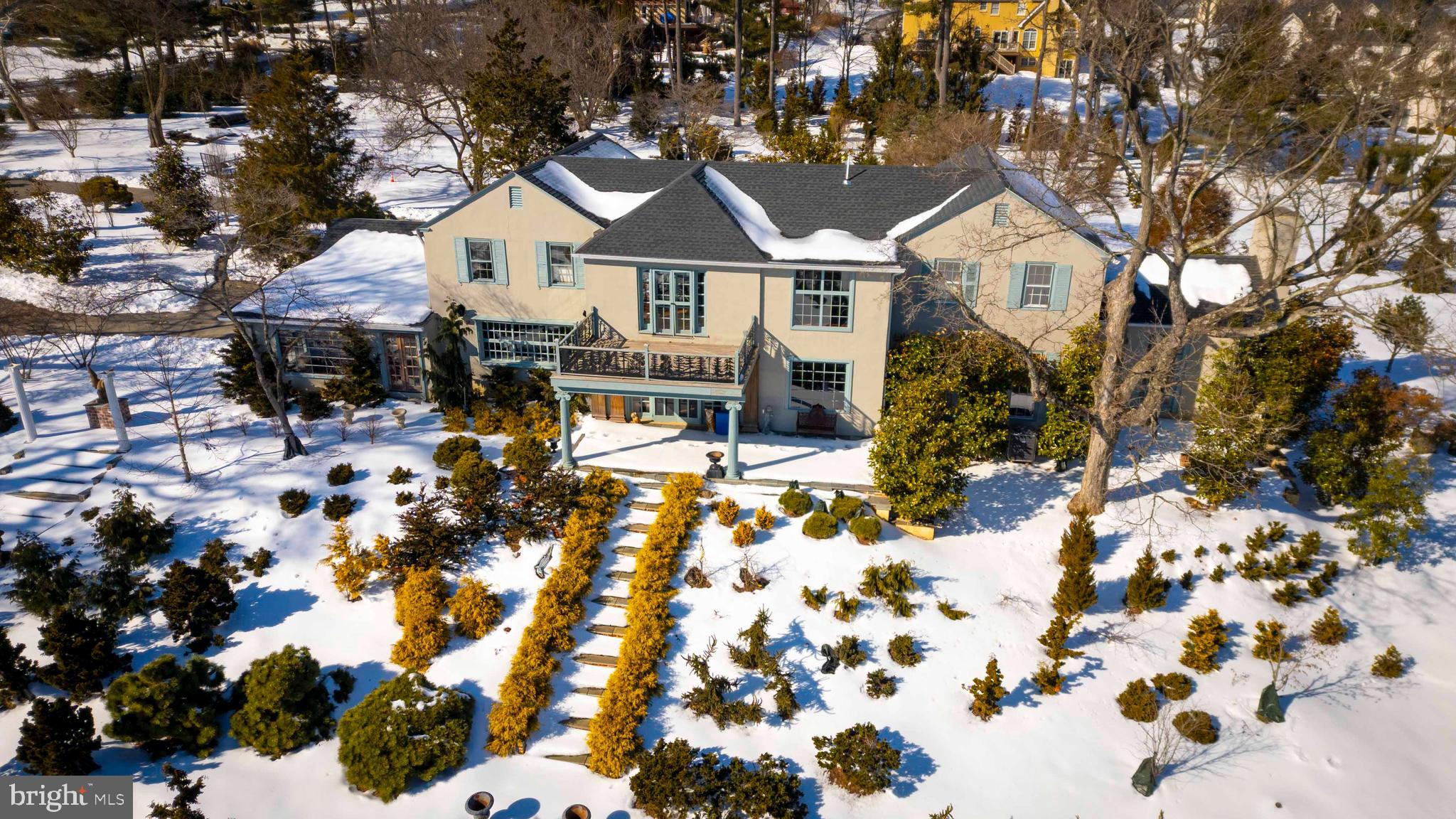 1260-2 County Line Road Wayne, PA 19087 - Photo 7 of 14 a front view of a house with a yard outdoor seating and covered with trees