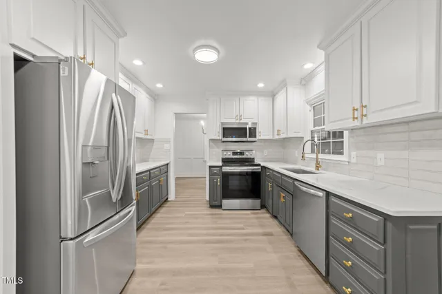a kitchen with granite countertop a sink stove and cabinets