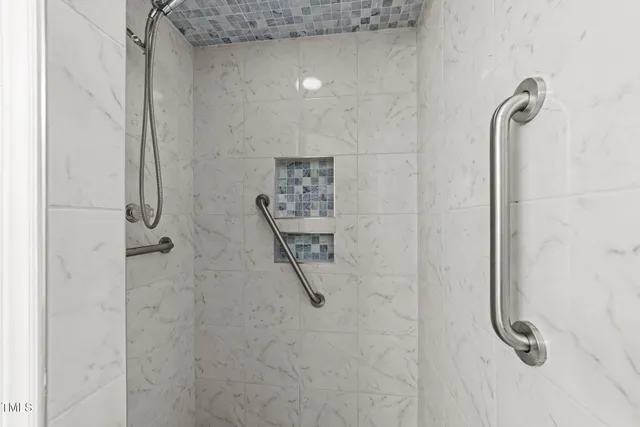 a view of a room with wooden floor and a ceiling fan