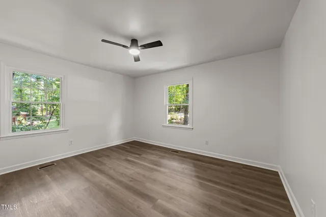 a view of a room with wooden floor and staircase