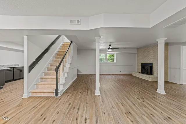 a living room with furniture a fireplace and a clock