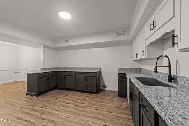 an empty room with windows and a ceiling fan