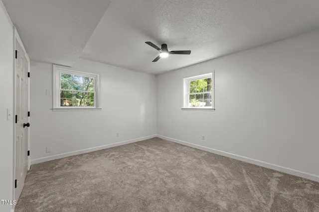 a view of a white house with a large windows and stairs