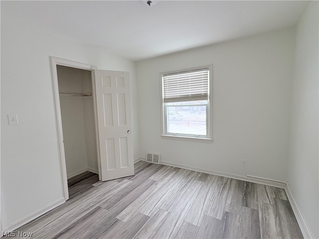 15521 Corkhill Road Maple Heights, OH 44137 - Photo 9 of 33 Unfurnished bedroom featuring light wood finished floors and a spacious closet