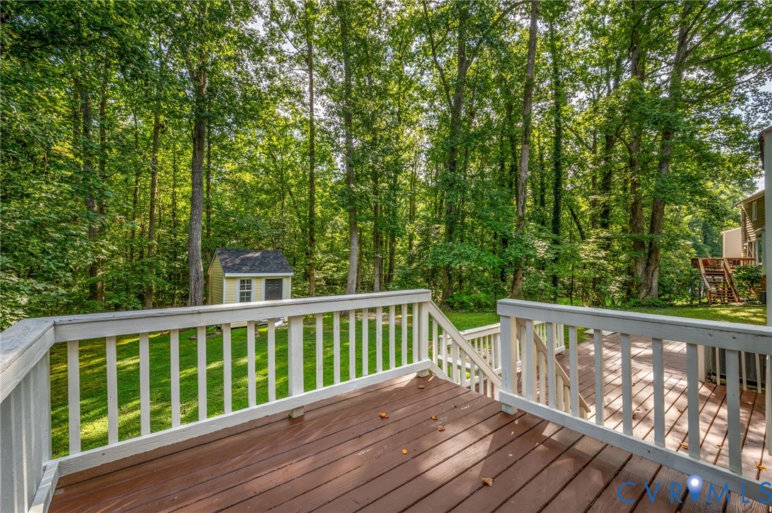 4820 Cedar Cliff Road Chester, VA 23831 - Photo 40 of 41 Expansive wood-finish deck with white railing over