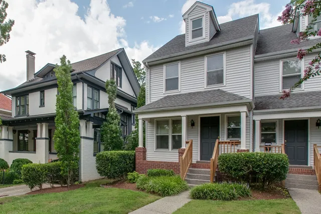a front view of a house with garden and porch