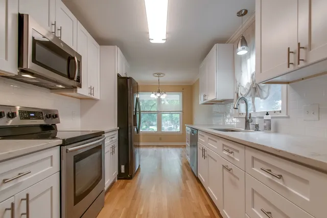 a kitchen with a sink stove and microwave