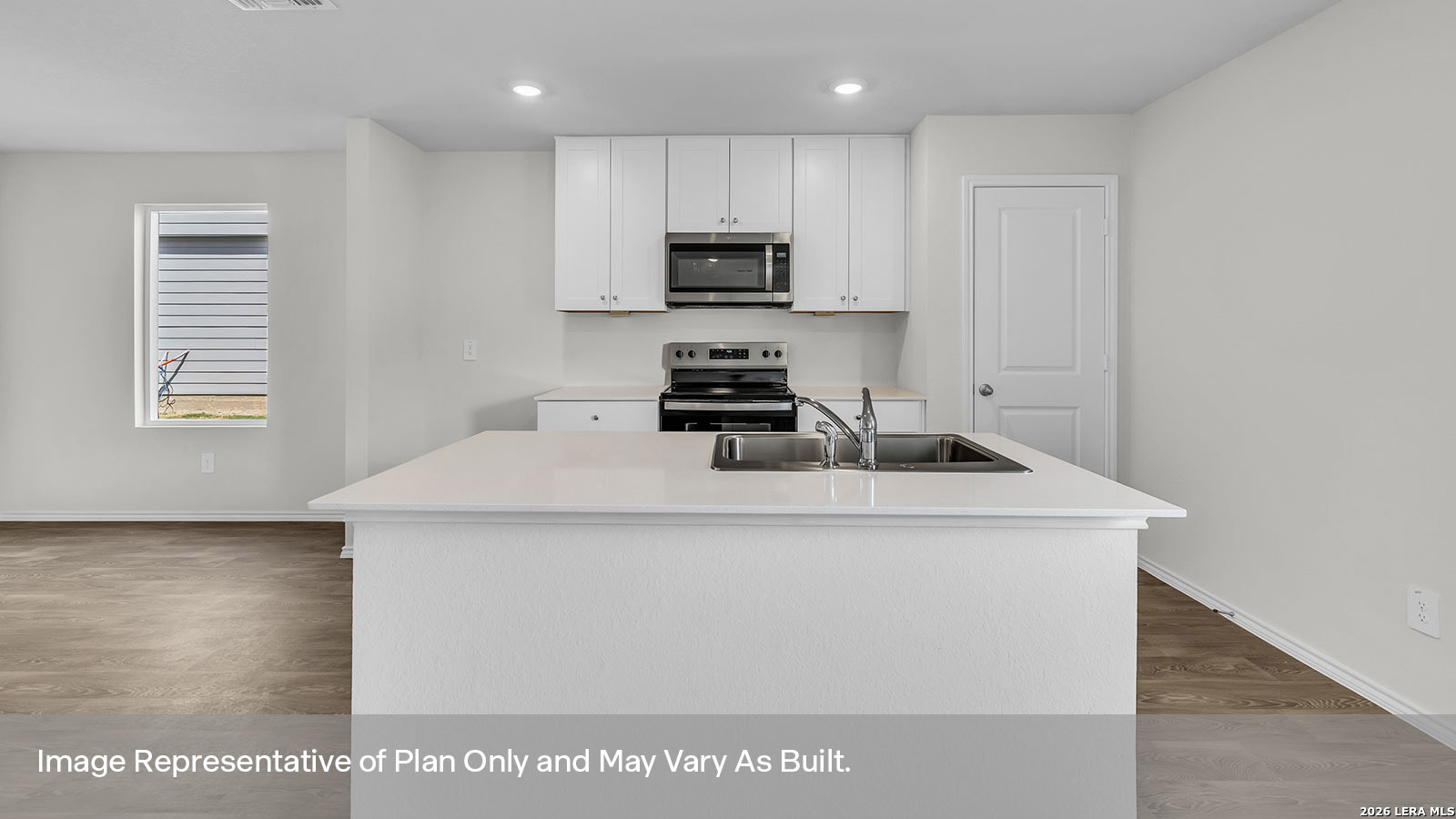 308 Windflower Cove Luling, TX 78648 - Photo 9 of 42 a kitchen with a sink a stove and microwave