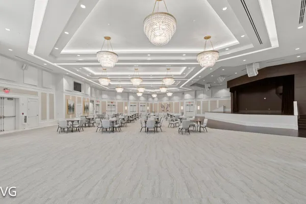 a view of hall way with furniture and chandelier