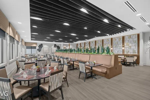 a outdoor dining space with furniture and wooden floor